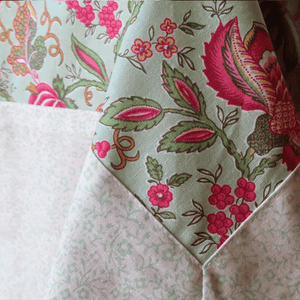 This lovely framed tablecloth allies bold floral patterns and fresh discrete flowers the best way. 